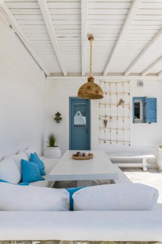a living room with a white couch and a blue door at Lunar Villa in Glastros