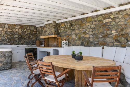 a kitchen with a wooden table and chairs at Lunar Villa in Glastros
