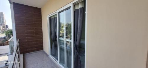 a balcony with sliding glass doors on a building at Happy Living in Noida