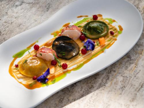a plate of food with vegetables on a table at The Dolli at Acropolis, A Hotel to Live in Athens