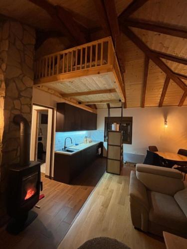 a living room with a fireplace and a stove at Rudnicka vila in Arandjelovac