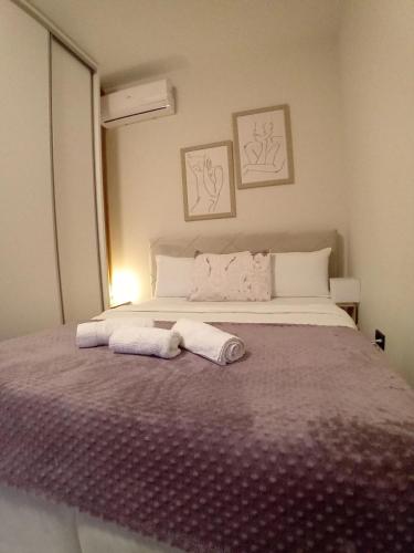 a bedroom with a bed with two towels on it at Blue apartment in Budva