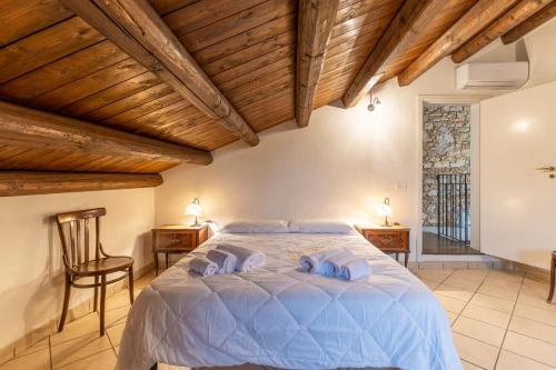 a bedroom with a bed with blue pillows on it at The Holiday And Art Seahorse House in Vittoria