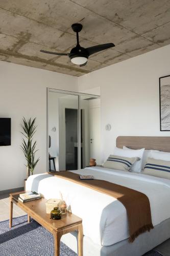a bedroom with a large bed and a ceiling fan at Mr. Rothschild by TLV2GO in Tel Aviv