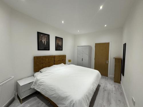 a bedroom with a large bed with white sheets at Beautiful 1-Bed Apartment in Walton on the Naze in Walton-on-the-Naze