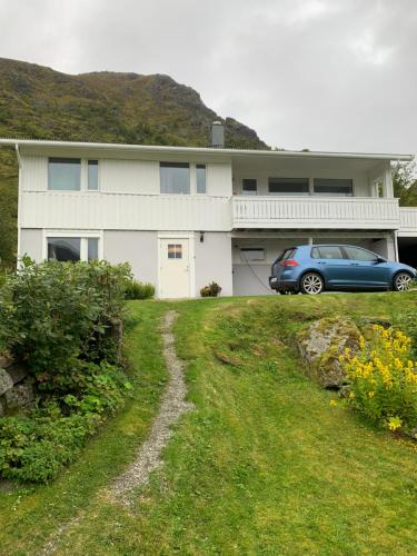 a house with a car parked in front of it at Liten leilighet med to soverom in Valberg