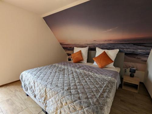 a bedroom with a bed with orange and white pillows at Nepalaya Ferienwohnung in Pegnitz