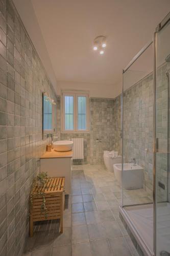 a bathroom with a shower and a tub and a sink at Primopiano - Verdi in Sesto San Giovanni