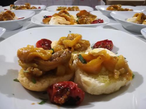 a plate of food with tomatoes on a table at Masseria Le Terrazze di Serranova in Serranova