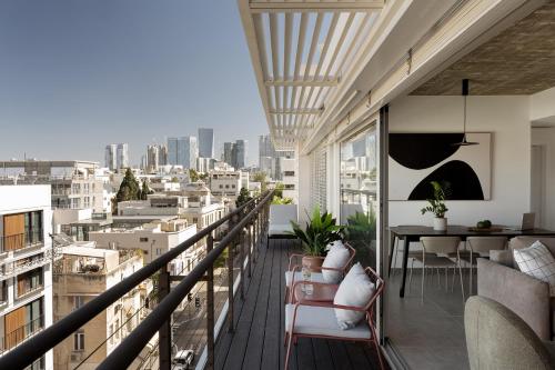 a balcony with a view of a city at Mr. Rothschild by TLV2GO in Tel Aviv