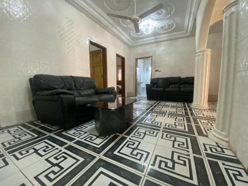 a living room with a couch and a floor at The Girls Guest house in Bathurst
