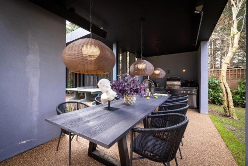 a dining room with a wooden table and chairs at The Brondesbury by Nestor in London