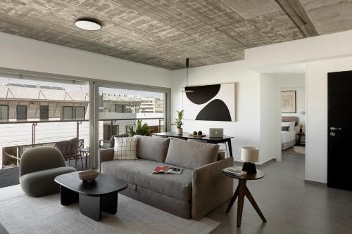 a living room with a couch and a table at Mr. Rothschild by TLV2GO in Tel Aviv