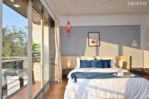 a bedroom with a bed with a tray of food on it at EKOSTAY Gold - Amara Villa in Alibaug