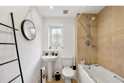 a bathroom with a toilet and a sink and a tub at Beautiful Lincoln Abode - Sleeps 6 - Parking in Lincoln