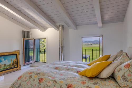 a bedroom with a bed and a large window at Incantevole vista dalle mura del castello. in Gradisca dʼIsonzo