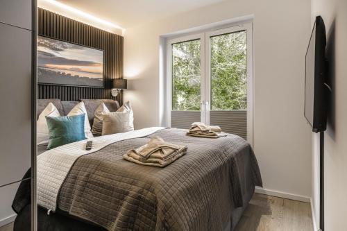 ein Schlafzimmer mit einem Bett mit zwei Handtüchern darauf in der Unterkunft Baltic House Möwe in Timmendorfer Strand