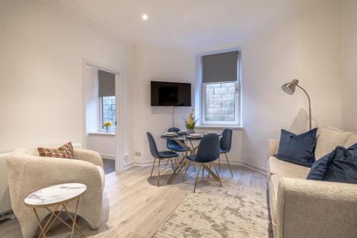 a living room with a couch and a table at Holburn Hideaway - SJA Stays - Luxury 2 Bed Apartment in Aberdeen