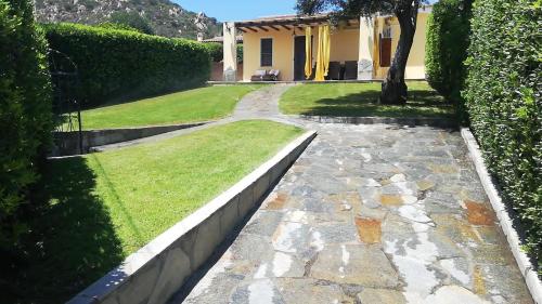 a walkway in front of a house at Villetta Valeria in Costa Rei