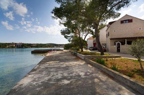 a walkway next to the water next to a building at Villa Nauta in Lovište