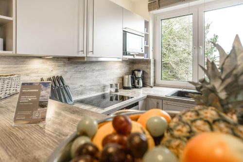a kitchen with a counter top with a bowl of fruit at Baltic House Sandburg in Timmendorfer Strand