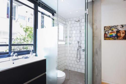 a bathroom with a shower and a sink and a toilet at Design 2BR in Dizengoff st by HolyGuest in Tel Aviv