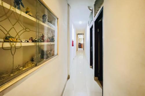 a hallway with a display case in a house at RedDoorz @ Best Hotel Jalan Dr. Sutomo Siantar in Pematangsiantar