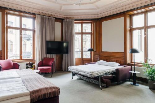 a hotel room with a bed and a tv at Scandic No 53 in Stockholm