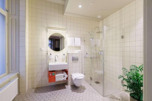 a bathroom with a shower and a toilet and a sink at Scandic No 53 in Stockholm