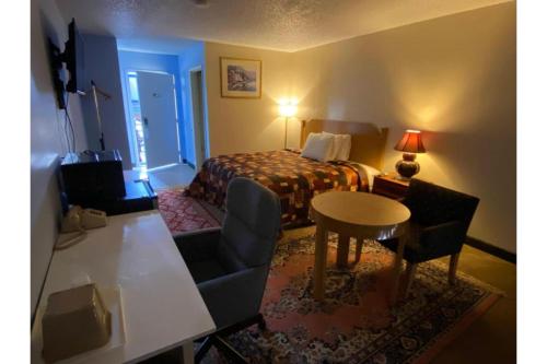 een hotelkamer met een bed en een tafel en stoelen bij Lake Country Inn in Riverside