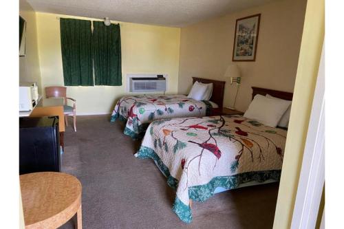 een hotelkamer met 2 bedden en een tafel bij Lake Country Inn in Riverside