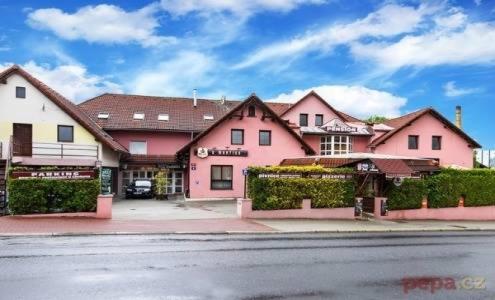a group of pink buildings on a city street at Penzion u Martina in Liberec