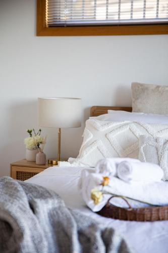 a bedroom with a bed with white towels on it at Sea View Guest House in Hobart