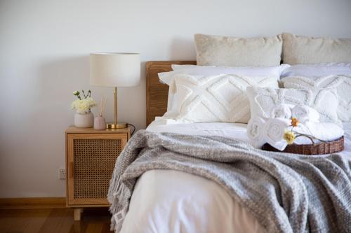 a bedroom with a white bed with a blanket on it at Sea View Guest House in Hobart