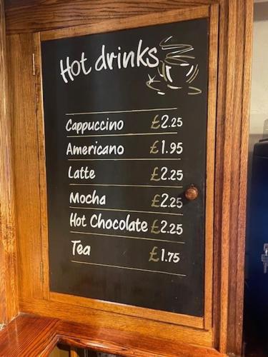 a chalk board with a hot drinks sign on it at Chequers Country Inn in Lutterworth
