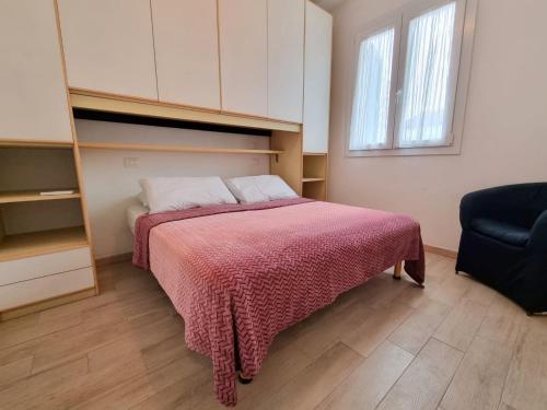 1 dormitorio con 1 cama con manta roja en Villa Demì, en Lido di Pomposa