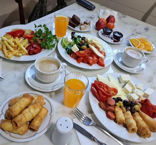 a table with plates of food on it at Ottoman Palace Hotel Edirne in Edirne
