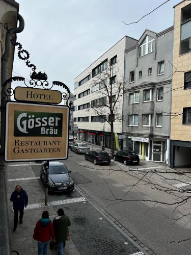 a group of people walking down a city street at Hotel Gösser Bräu in Wels