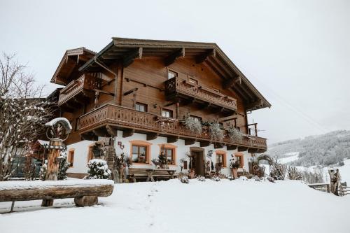 a large wooden house in the snow at Schranbachhof in Maria Alm am Steinernen Meer
