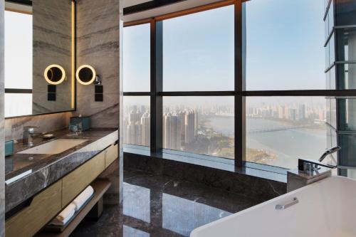 a bathroom with two sinks and a large window at Wuhan Marriott Hotel Wuchang in Wuhan