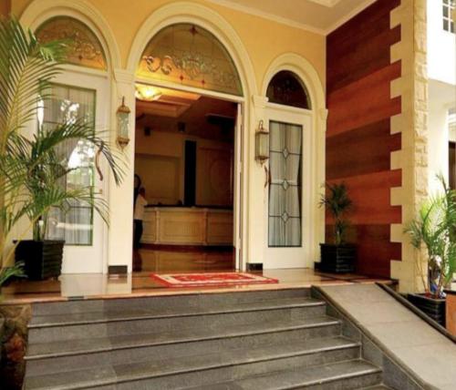 an entrance to a house with stairs and a door at Cove Ottenville Boutique Hotel in Bandung