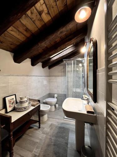 a bathroom with two toilets and a sink at Il Sulé in Giaveno