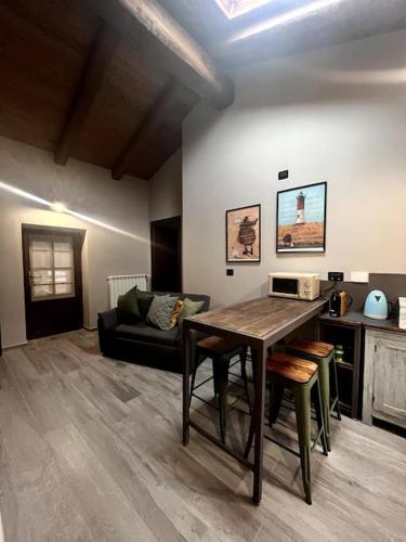 a living room with a table and a couch at Il Sulé in Giaveno