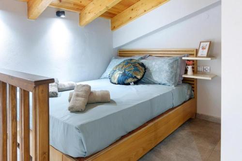 a bed with a wooden frame in a room at Old Town Studio's Rethymno City in Rethymno
