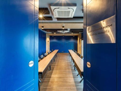 a row of benches in a room with blue walls at Novotel Koh Si Chang in Ban Phanu Rangsi