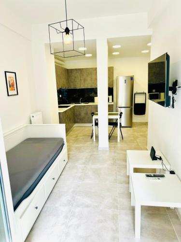 a living room with a bed and a kitchen at Ηarmony 2 apartment next to the Acropolis museum in Athens