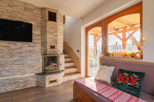a living room with a fireplace and a tv at Luxury Vineyard Retreat Matej - Happy Rentals in Trebnje