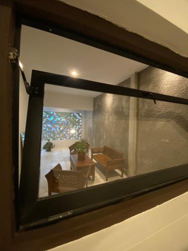 a view of a living room through a window at Sare Living Homestay in Timuran