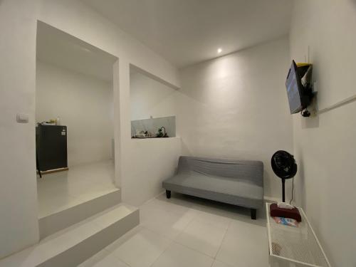 a room with a bed and a tv on a wall at Sare Living Homestay in Timuran