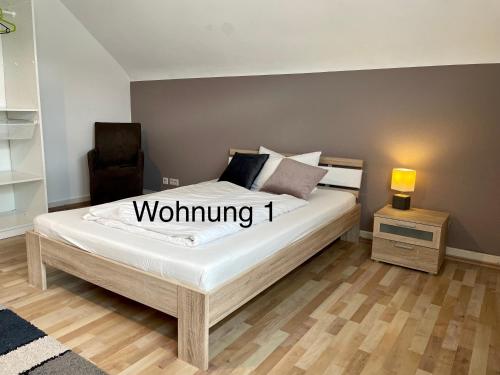 a bedroom with a bed and a night stand with a lamp at Ferienwohung Weinheim in Weinheim